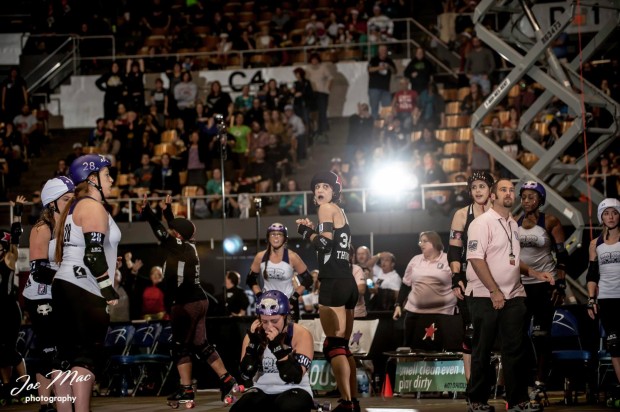 The Agony and the Ecstasy: The moments following the final whistle of the 2014 WFTDA Championship game, with Gotham defeating Rose City 147-144. (Photo by Joe Mac)